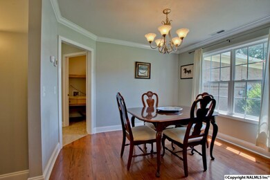 in the elegant Dining Room boasting those gorgeous hardwoods and more crown molding.
