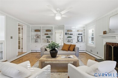 A large family room with built-in bookcases and wood burning fireplace.