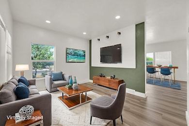 Living room featuring wood finished floors and recessed lighting