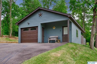 This guest house, man cave, bar room has so much potential!  The kitchenette, bath, one car garage, and covered porch make it perfect for entertaining at the lake!
