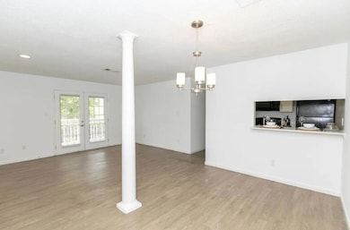 Unfurnished living room with an inviting chandelie