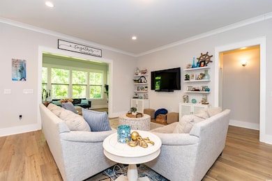 Living room with recessed lighting, baseboards, or
