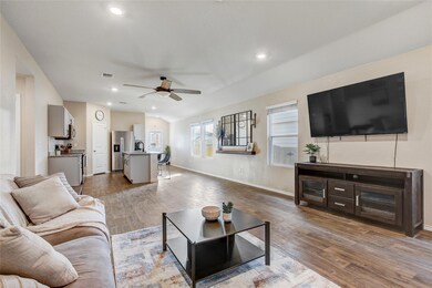 Living room featuring ceiling fan, dark wood fini