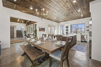 Dining space with a notable chandelier and wood ce