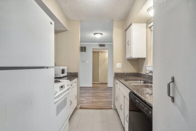 Kitchen featuring white cabinetry, white appliance