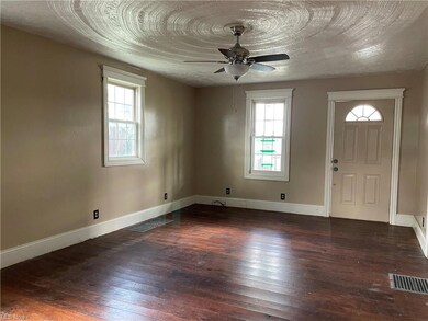 Hardwood floored foyer with ceiling fan