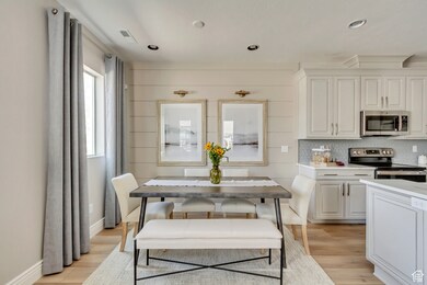 PHOTOS FOM SIMILAR MODEL HOME. FINISHES, COLORS, AND OPTIONS WILL VARY. Dining room featuring light wood-style flooring and recessed lighting