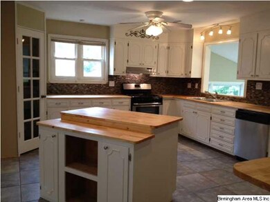 Kitchen has ceramic tile and a new stone backsplas