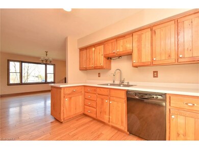 Kitchen with oak cabinetry and matching hardwood f
