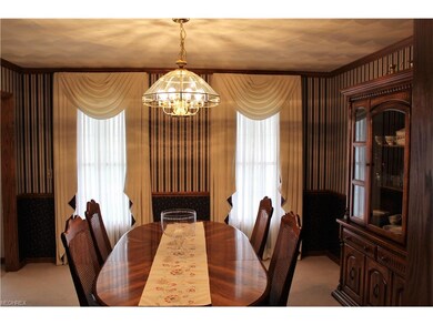 Formal dining area just off the entry boasts crown