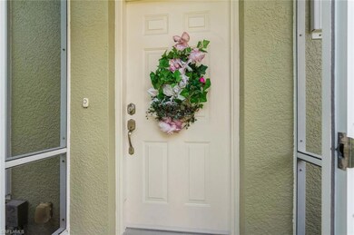 Doorway to property with stucco siding