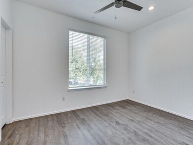 Empty room with hardwood / wood-style flooring and