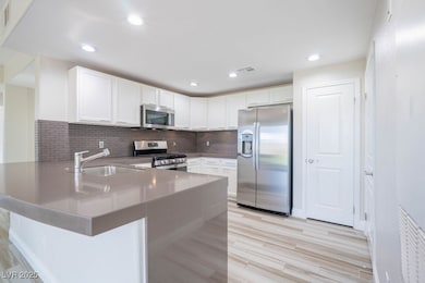 Kitchen featuring stainless steel appliances, a si