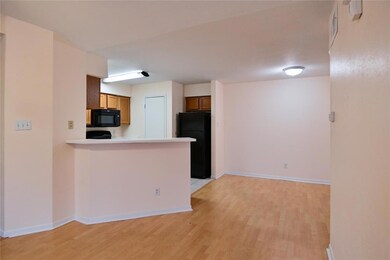 Kitchen featuring black appliances, light wood-ty