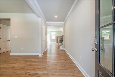 Corridor featuring crown molding and hardwood / wo