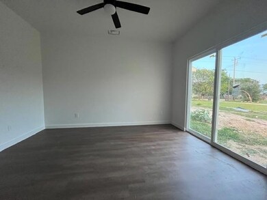 Empty room with baseboards, a ceiling fan, and da