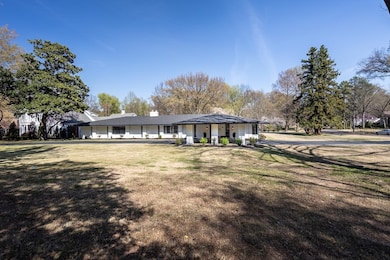 View of front of house featuring a chimney and a front lawn