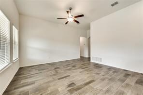 Spare room featuring hardwood / wood-style floors and ceiling fan