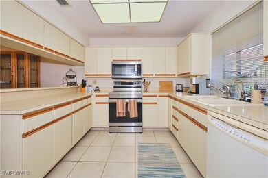 Kitchen with stainless steel appliances, a sink, l