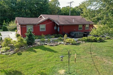Back of home with patio and hot tub