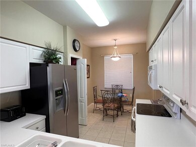 Kitchen featuring white cabinets, pendant lighting