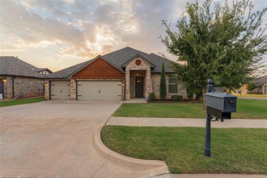 View of front of property with a garage and a lawn