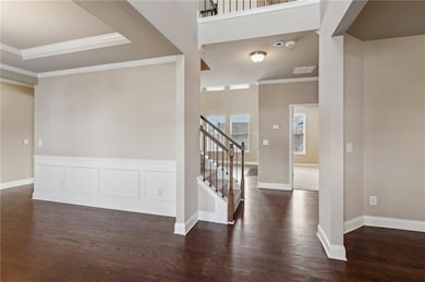 Foyer featuring stairs, dark wood-style flooring, 