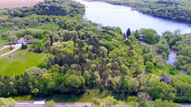 The lot sits perched above the road giving the feel of overlooking the surrounding area.  With the clearing some additional trees bring the river and Lake Caroline into your views.
