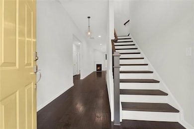 Foyer with baseboards, recessed lighting, a warm l