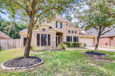 Beautiful trees in front yard and shrubbery that accents the all side brick home