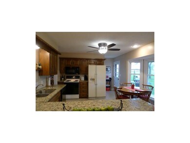 Spacious eat-in kitchen features tiled backsplash 
