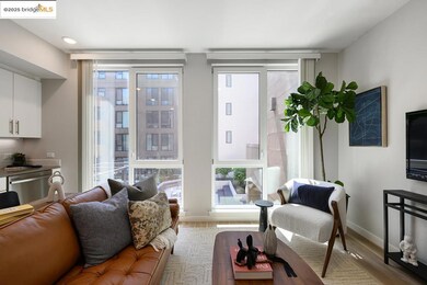 Living area with floor to ceiling windows and light wood-style flooring