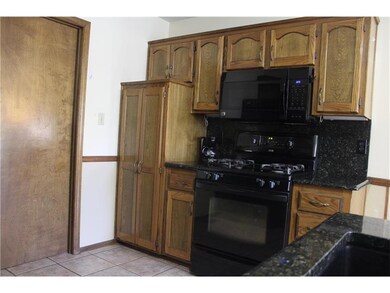 beautiful cabinetry  with pantry, granite counters