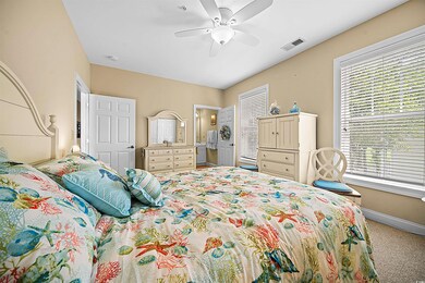 Carpeted bedroom with ceiling fan