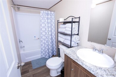 Full bathroom featuring hardwood / wood-style floo