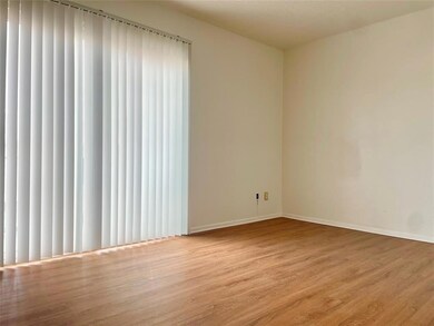 Empty room featuring baseboards and wood finished