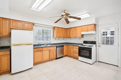 Kitchen featuring ceiling fan, light tile patterne