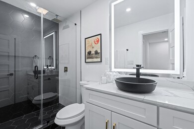 Bathroom with recessed lighting, vanity, a stall 