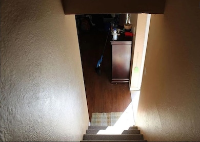 Stairs featuring hardwood / wood-style floors