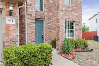 Property entrance featuring brick siding