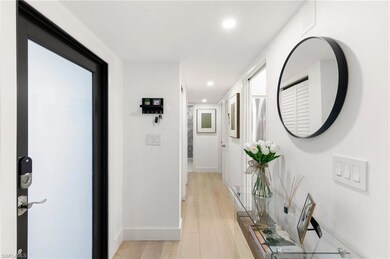 Corridor with light wood-style flooring, baseboard