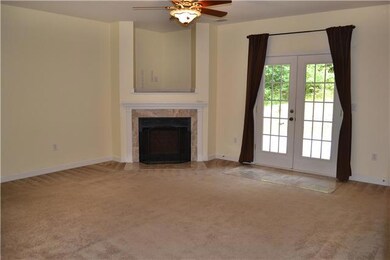 A corner fireplace with marble tiled hearth & surround highlight the open Living Room. A recessed television nook is located above the fireplace that helps to hide unsightly cords.