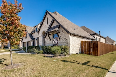 View of home's exterior with roof with shingles, brick siding, a garage, and concrete driveway