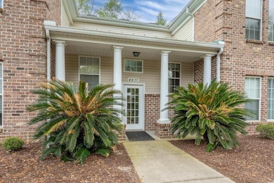 Entrance to property featuring brick siding