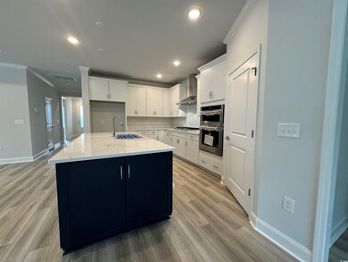 Kitchen featuring white cabinets, sink, a kitchen 