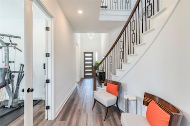 Entrance foyer featuring wood finished floors, st