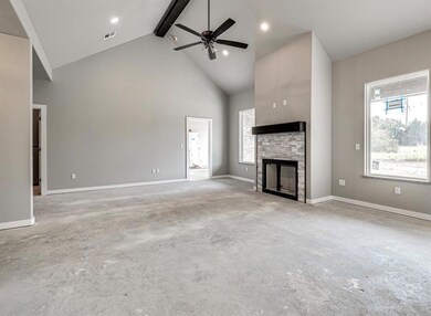 Unfurnished living room with a fireplace, beamed c