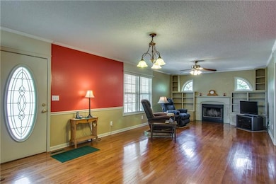Living Room w/ gas fireplace, Built-Ins, opens to the Kitchen and bedroom.