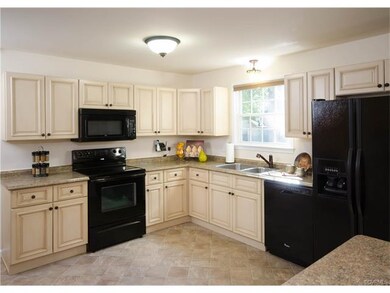 The kitchen has been renovated with new cabinetry,