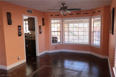 11x10 dining area with ceiling fan. Wooden blinds